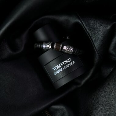 Luxury Tom Ford Ombré Leather fragrance bottle styled on dark leather backdrop.